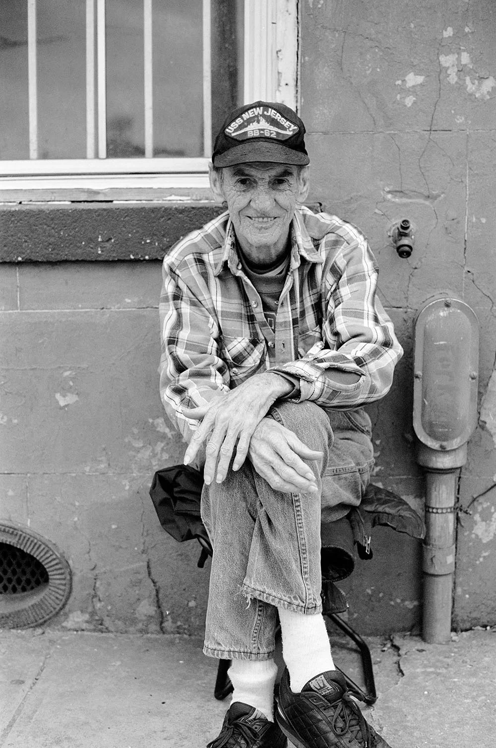 Black and white portrait of a friendly old man.