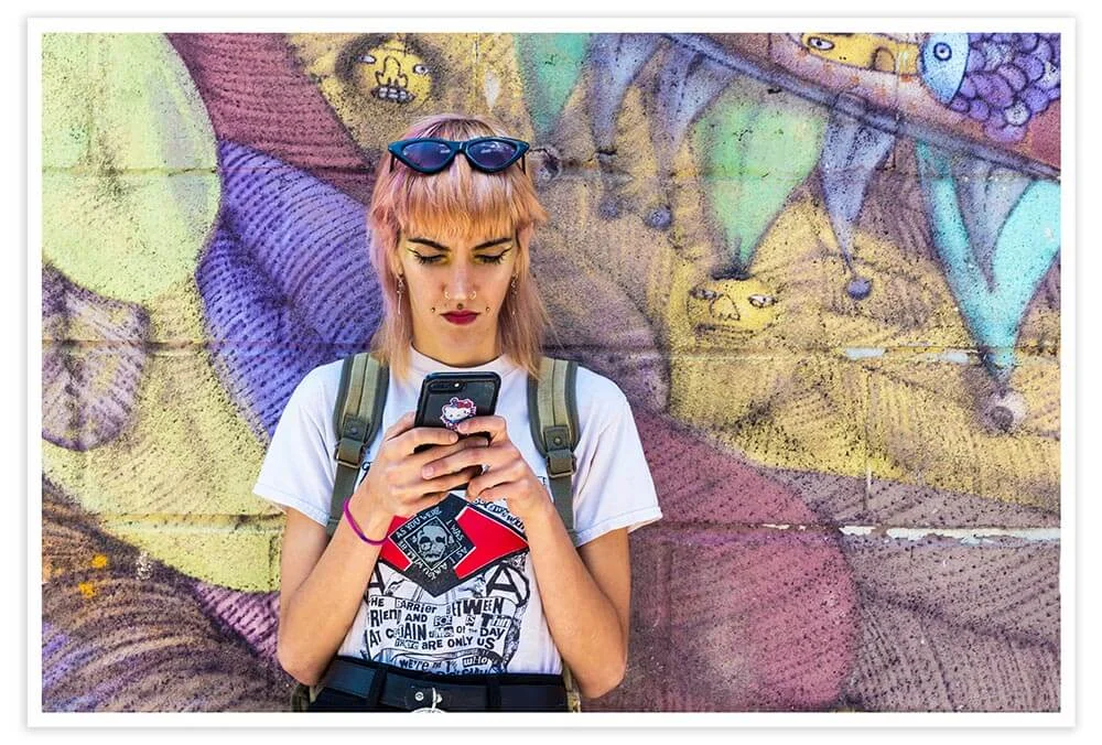Texting directions to a friend on the corner of Surf Avenue.