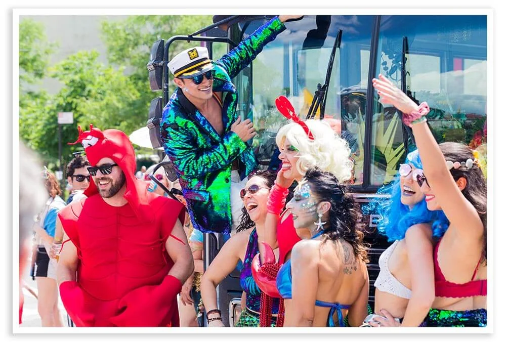 A party bus idles, waiting to join the parade.