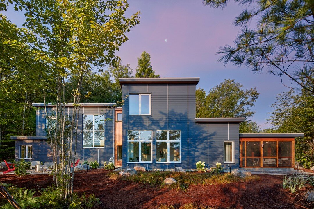 Photographed this beautiful, distinctive and prominent Passive House design at Lake Winnipesaukee, NH. A third quarter moon falls behind the facade facing the lake at first light. The shot at night is an approaching view that doesn&rsquo;t hint at th