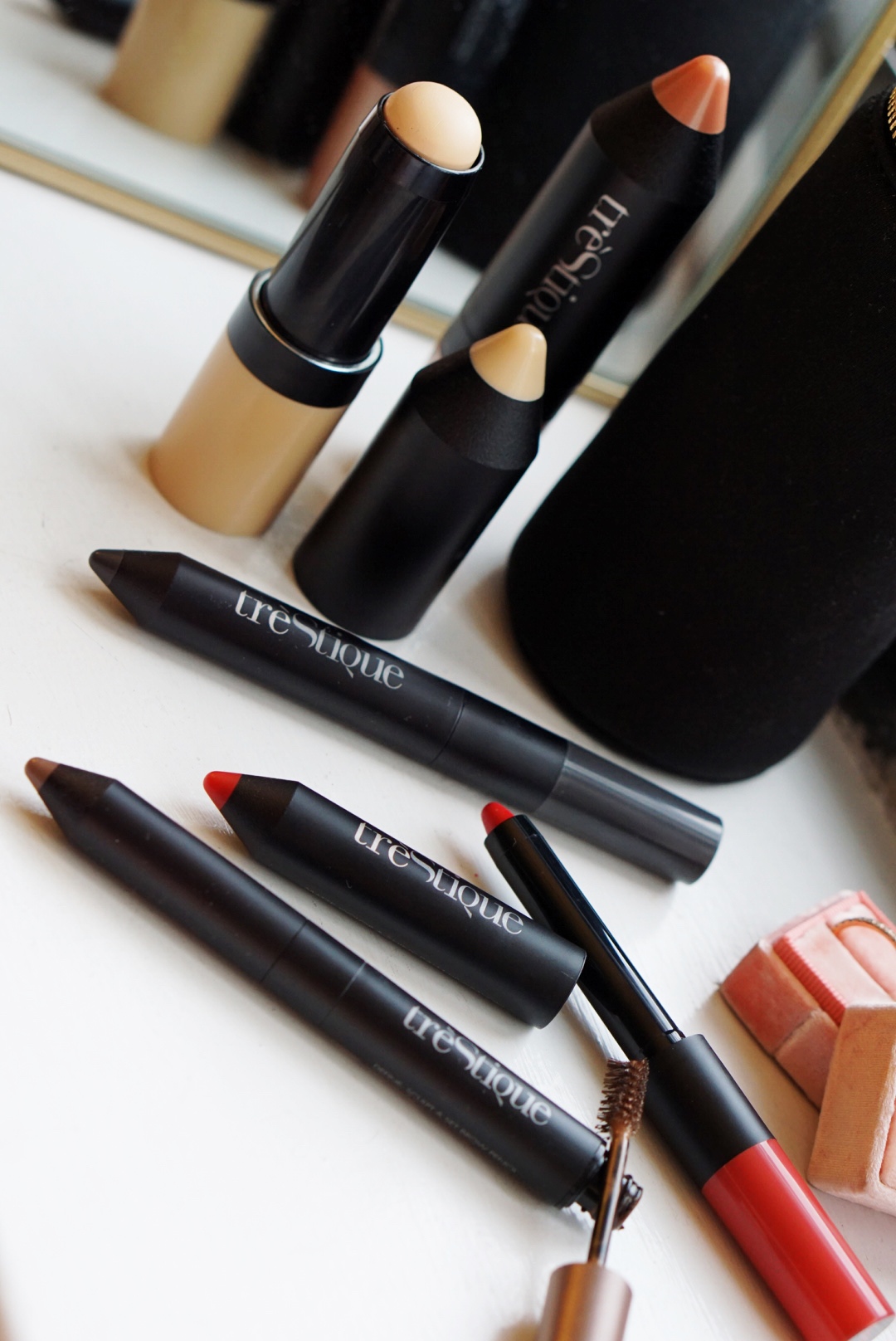 Products shown here include the Tinted Face Stick, Bronzer Stick, Shadow Crayon, Brow Pencil and the Lip Crayon.