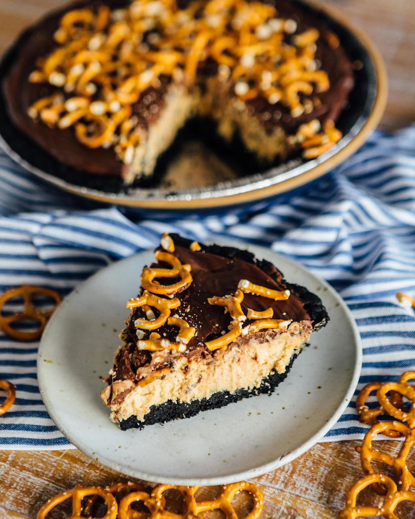 Super Bowl countdown has begun! This weekend we are featuring our Touchdown Peanut Butter Pie!
This pie is an annual fan favorite with a light fluffy peanut butter filling in a housemade oreo cookie crust all topped with a chocolate ganache and pre