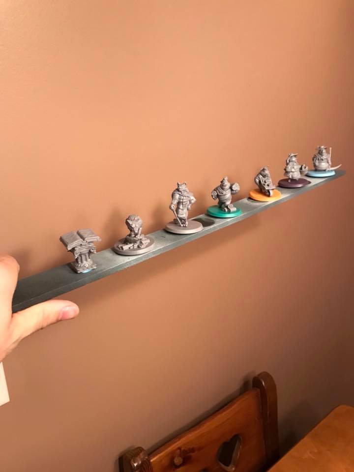 In this photo, you can see that I’ve placed a small bit of tack under each model. I attached my models to a small piece of wood. Thick cardboard will also work.