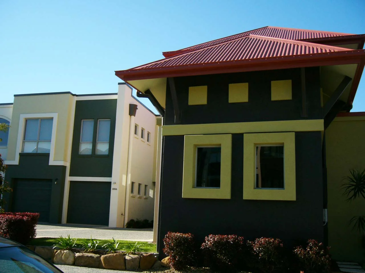 Jennifer Fair Interior and Exterior Designer Emerald Lakes Gold Coast Home Exterior Rusty Red and Green Colour Accent