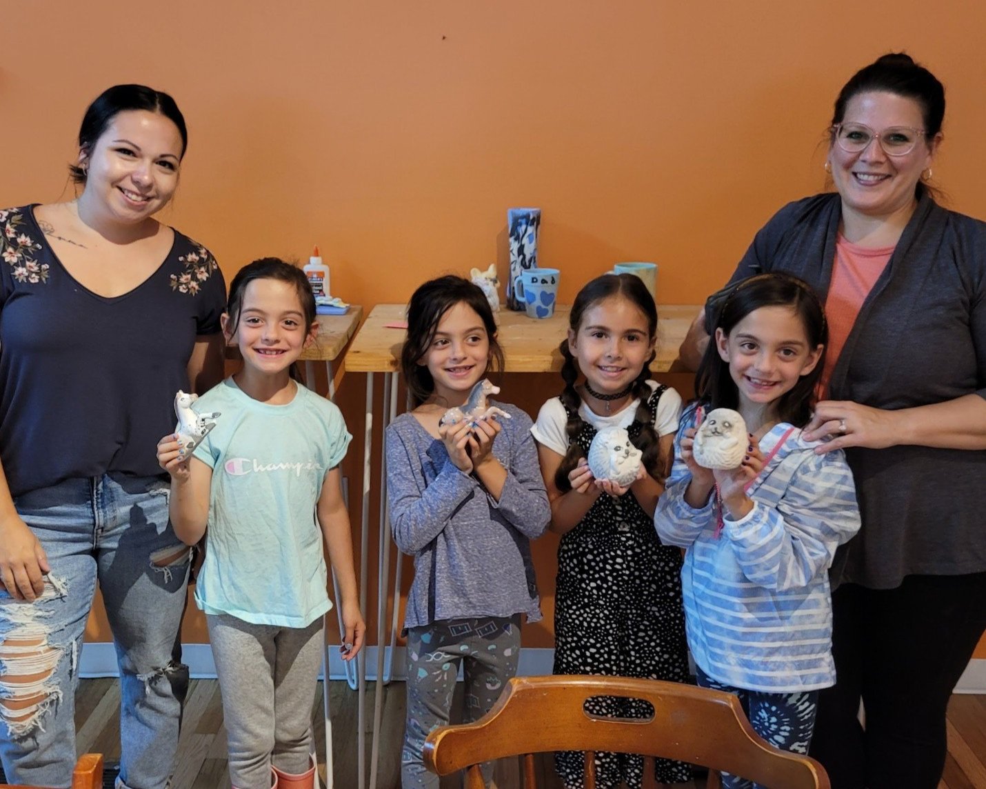 Friends and family display their painted figurines.