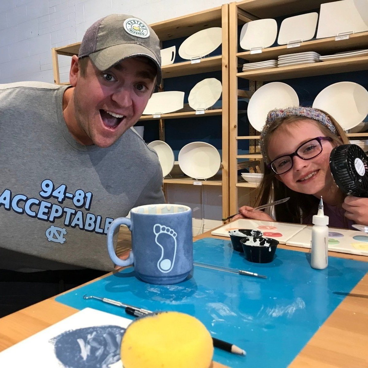 Father and Daughter create personalized mug.