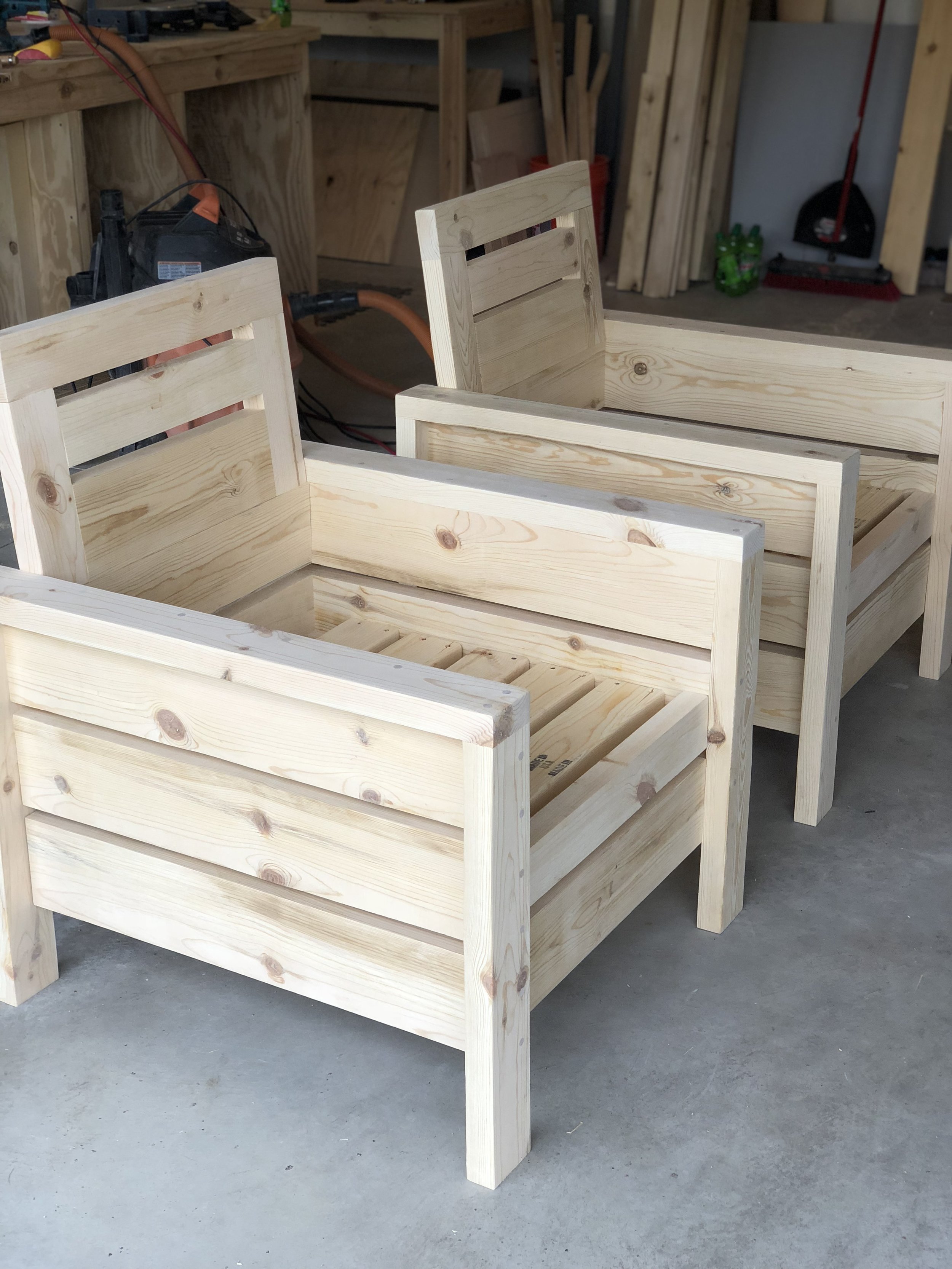 Here are the chairs before I stained them. The simple design and clean lines made these the perfect choice for our front porch. With a per chair cost of $30 in building material, $60 in cushions and $10 in stain we were able to achieve the look of a much more expensive chair.