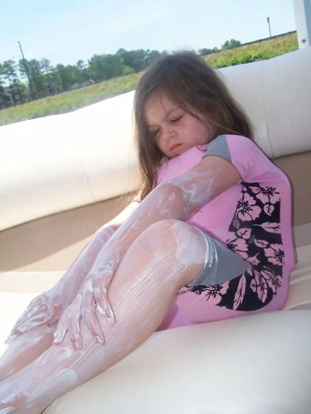 My 6-year old daughter. I think she's wearing a life vest under a body suit, because you can never be too careful, people. Put on your own sunscreen, kid.