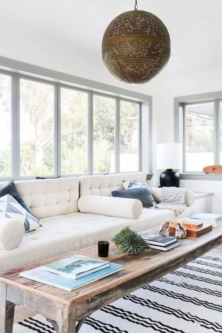 A Malibu farmhouse’s comfy neutral sunroom, via My Domaine.