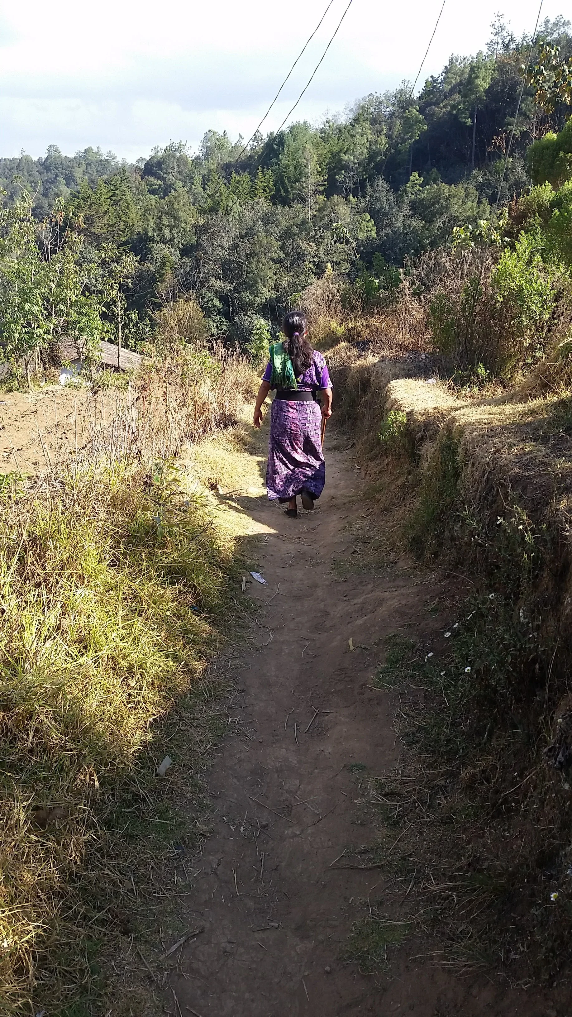 A midwife walking the path she takes to reach her patients in the rural highlands of Guatemala.