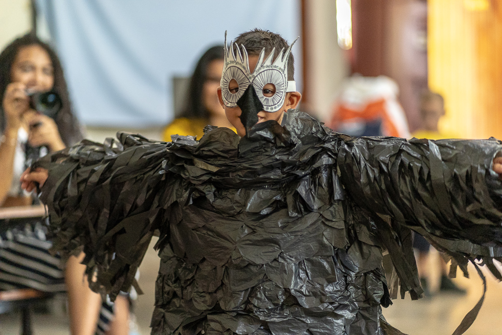 A young boy showing off his bird costume he made using 100% recycled materials at the Madres Maestra community centre.
