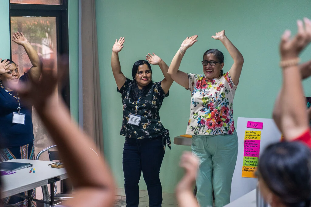 (left to right) Katherine Martinez and Cristina Alvarado from Visitacion Padilla, Women’s Movement for Peace (Honduras) leading waking everyone up with an interactive dance!
