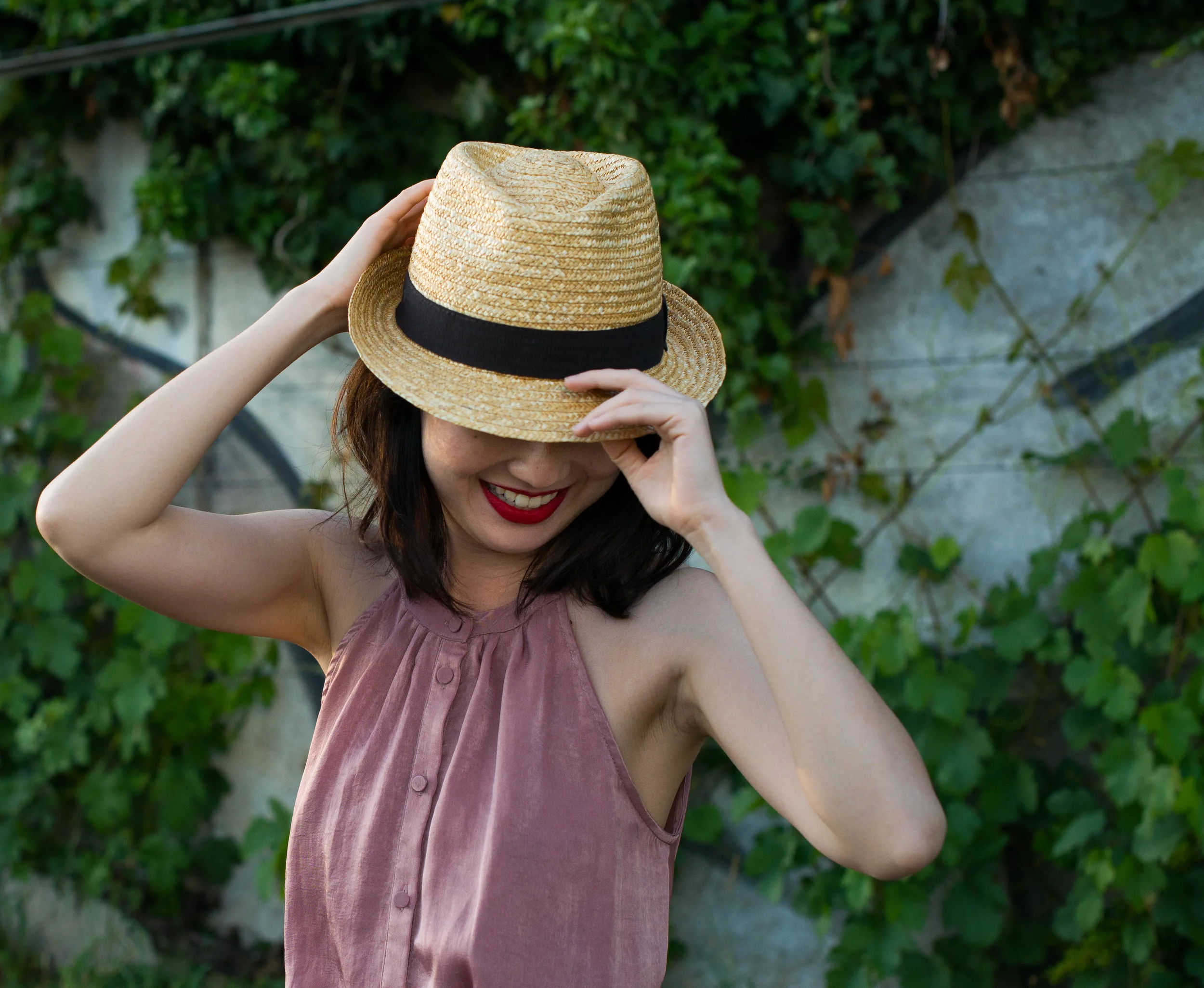 model smiling under the hat