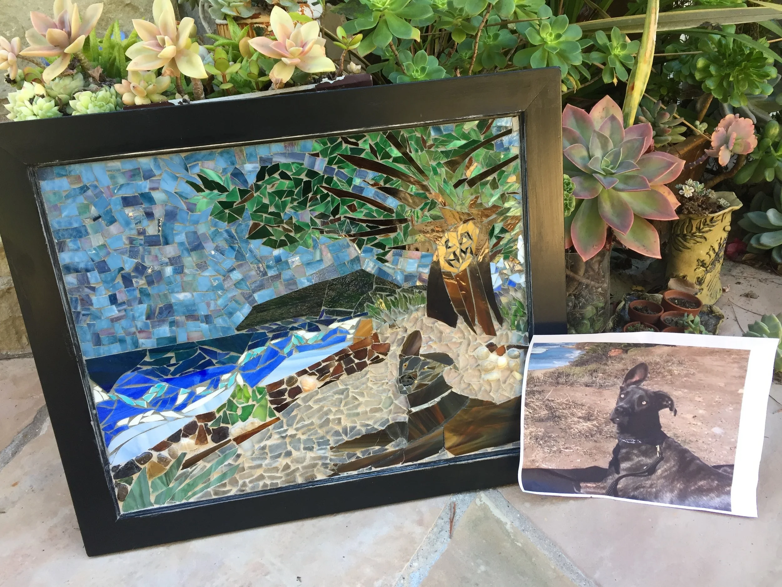  This dog was extremely difficult to do her ears and eyes. She is sitting up at the Carpinteria Bluffs. I put her initials in the tree. I used lots of sea glass from Scotland.&nbsp; 