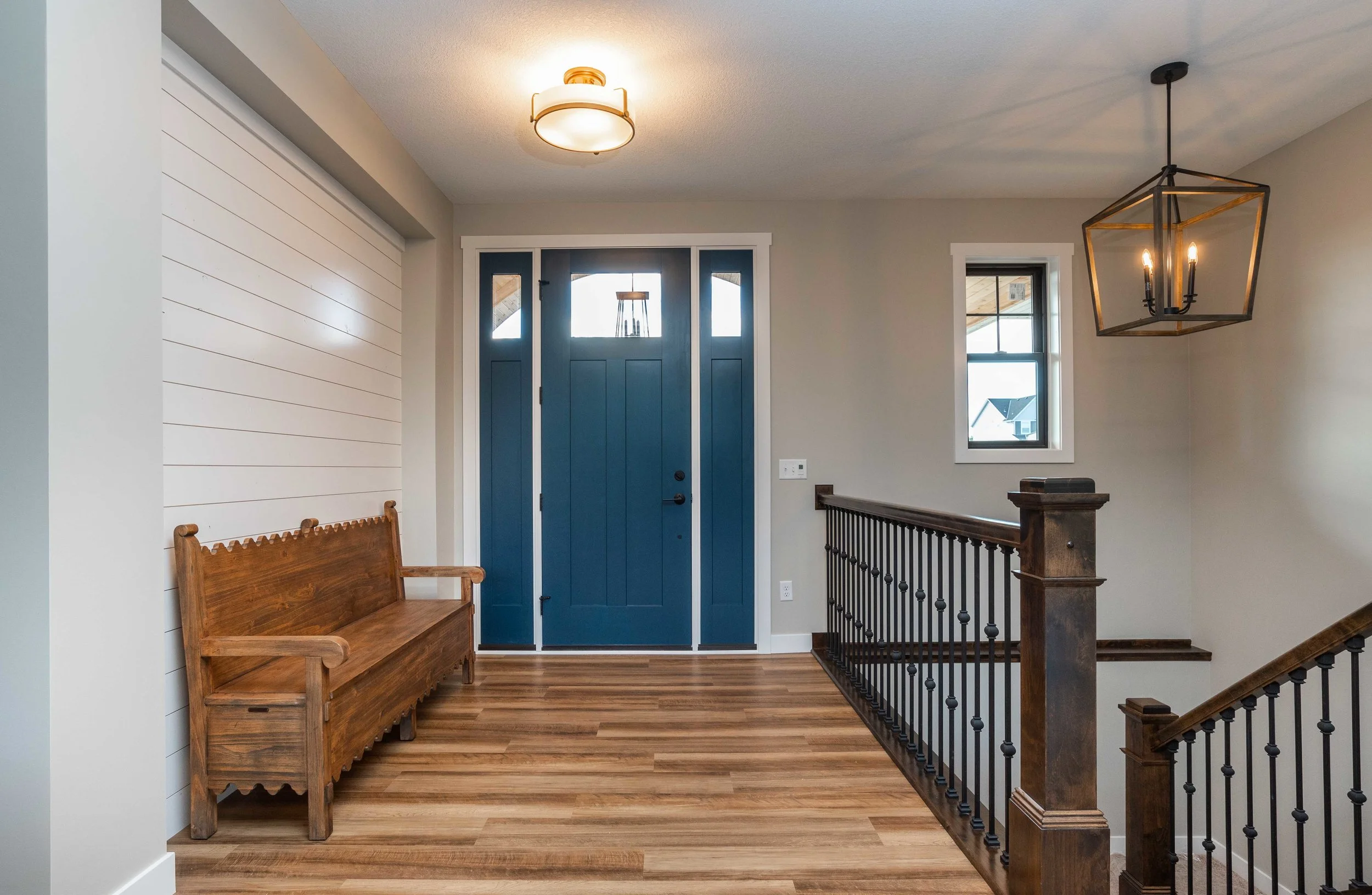 This beautiful blue door and ship lap wall make for a stunning entry way!