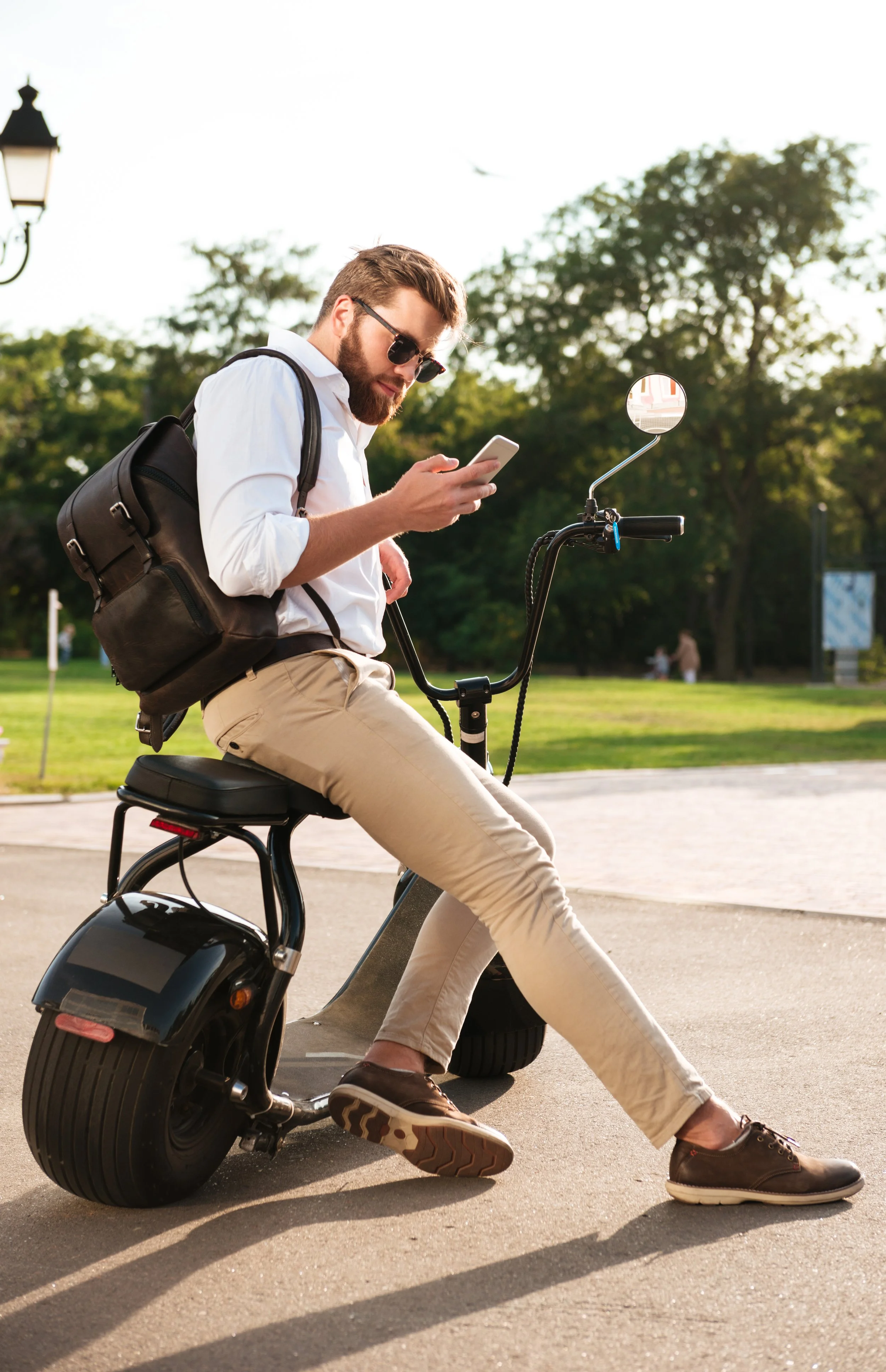 full-length-side-view-bearded-man-sunglasses-sitting-modern-motorbike-outdoors-using-smartphone.jpg