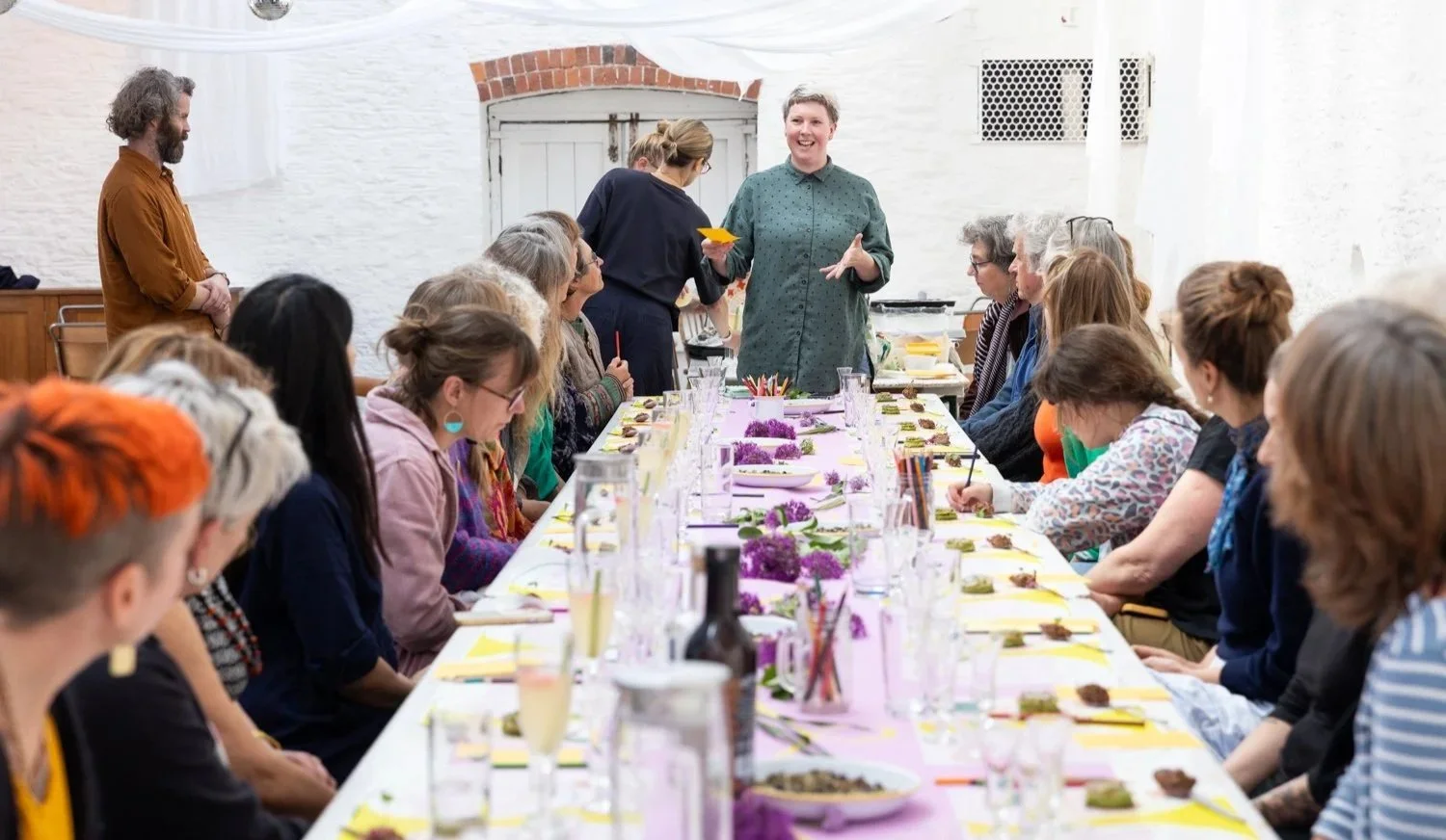 Artist chef introduces meal to busy table