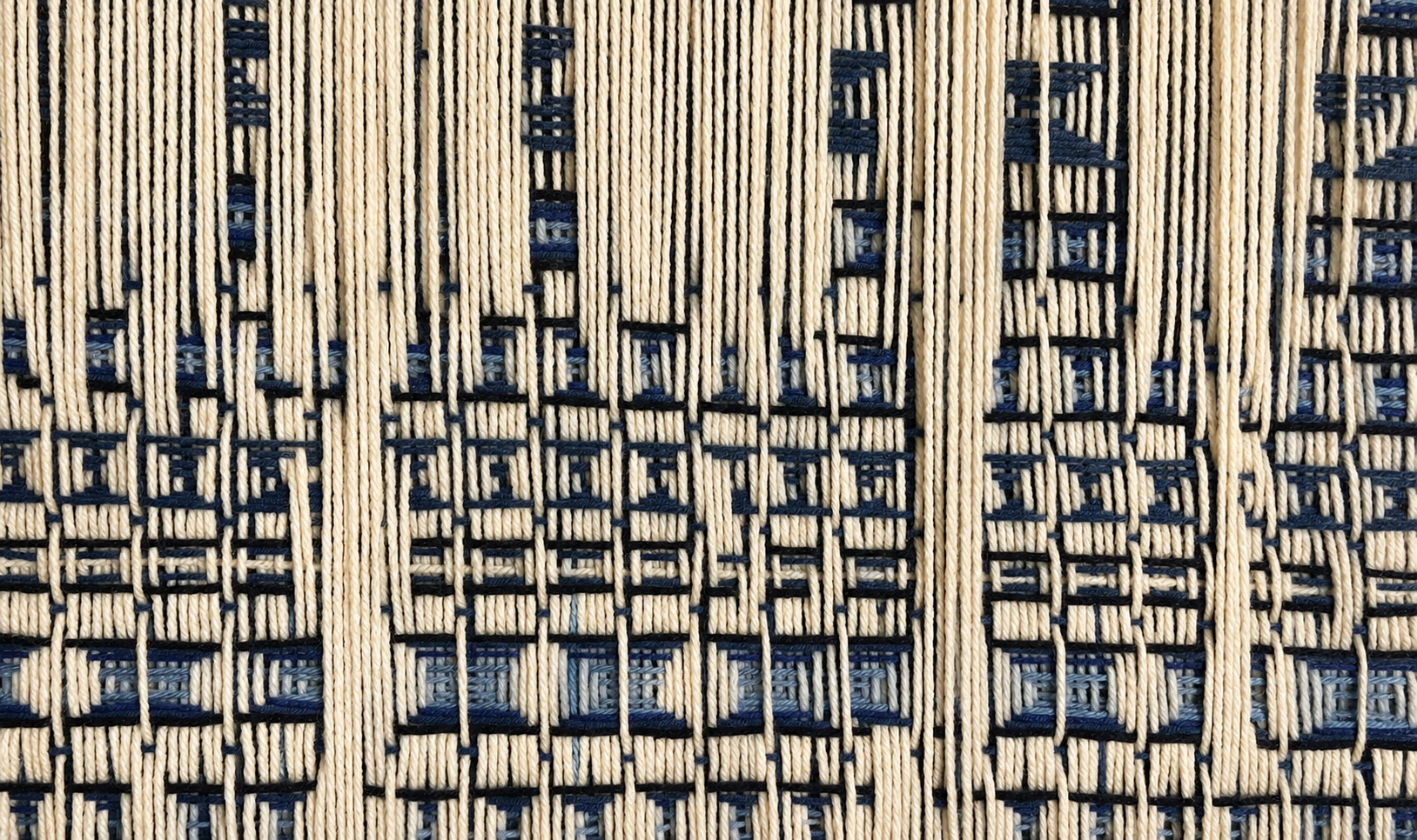 Muted navy and ivory woven textile.png