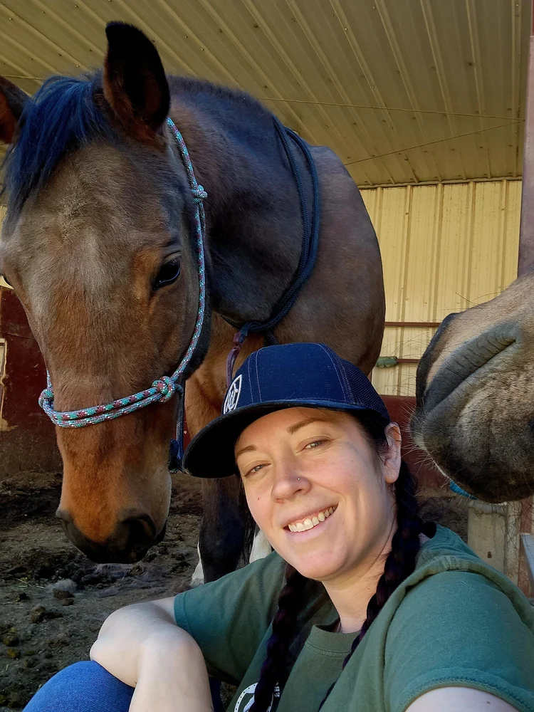 Andrea Money sitting with a horse named Sadie