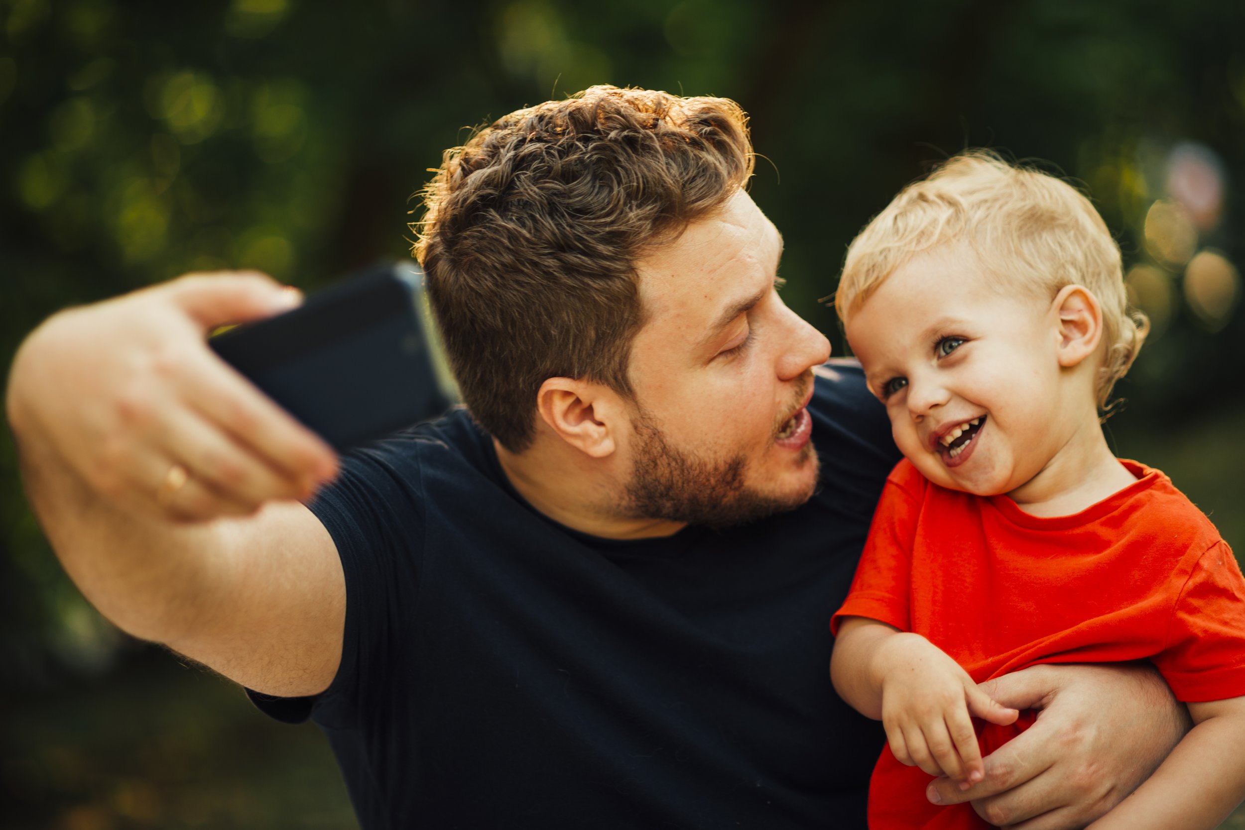 father-taking-selfie-looking-his-child.jpg
