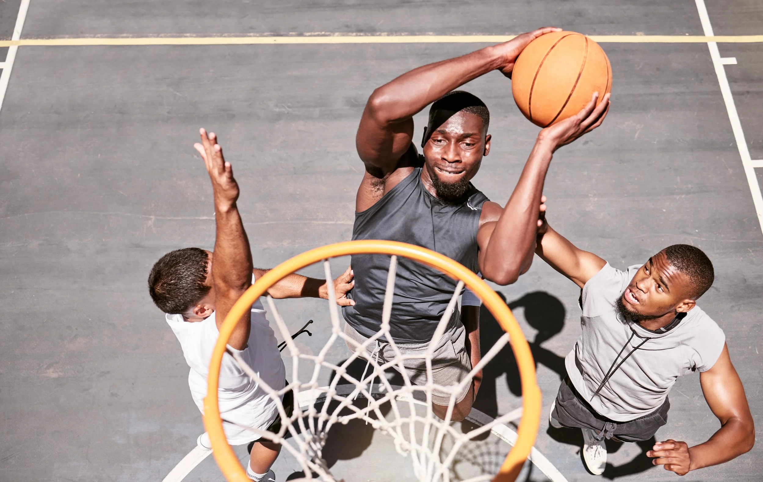 basketball-players-blocking-player-from-dunking-ball-into-net-score-points-match-sports-court-from-fit-athletes-jumping-defend-competitive-game-recreational-fun.jpg