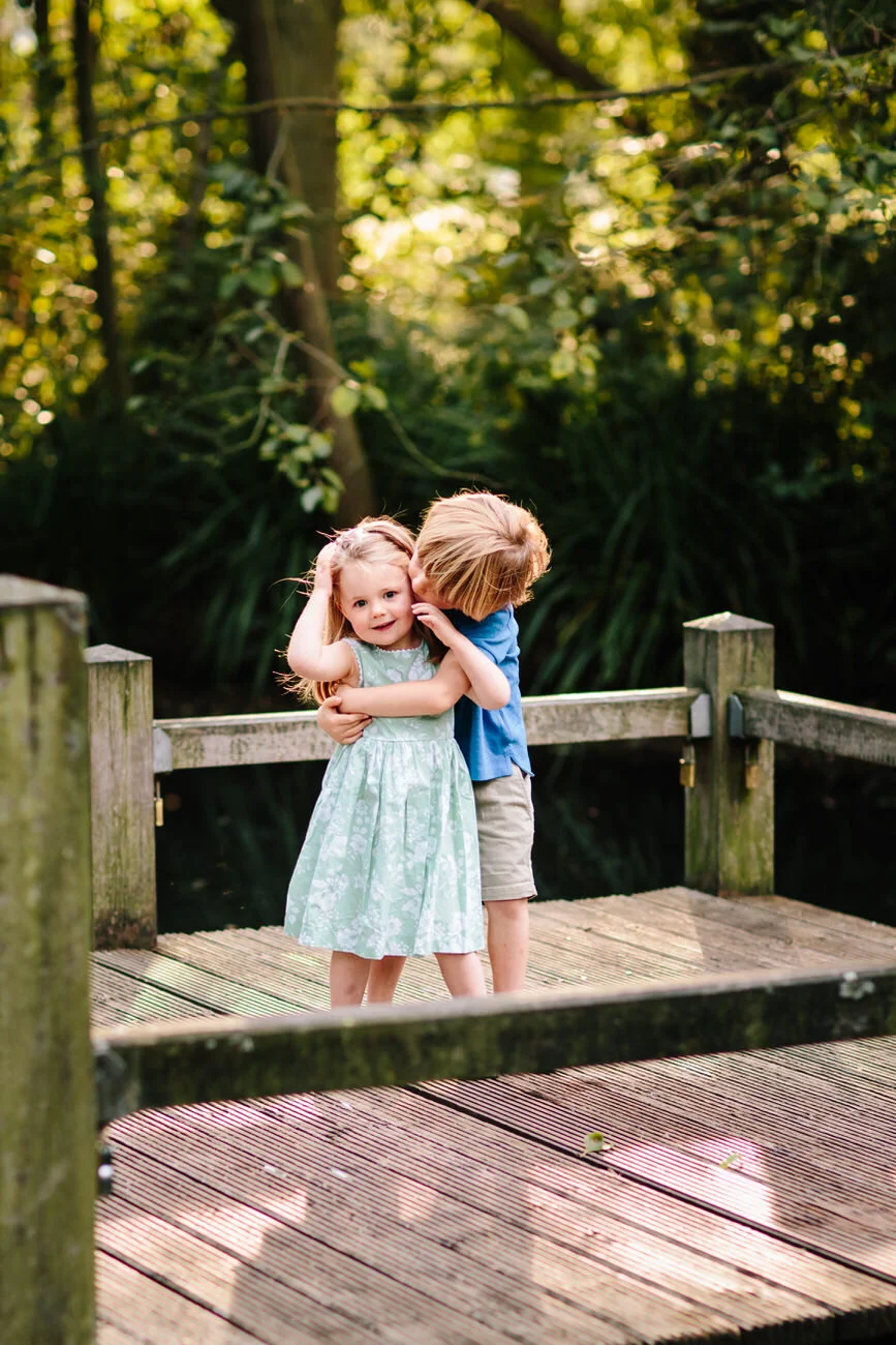 Sunset family photoshoot on Wandsworth Common with brother and sister cuddling