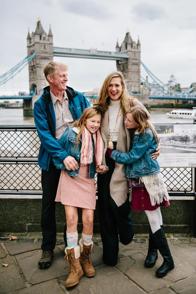 Family laugh for professional photographer by Tower bridge