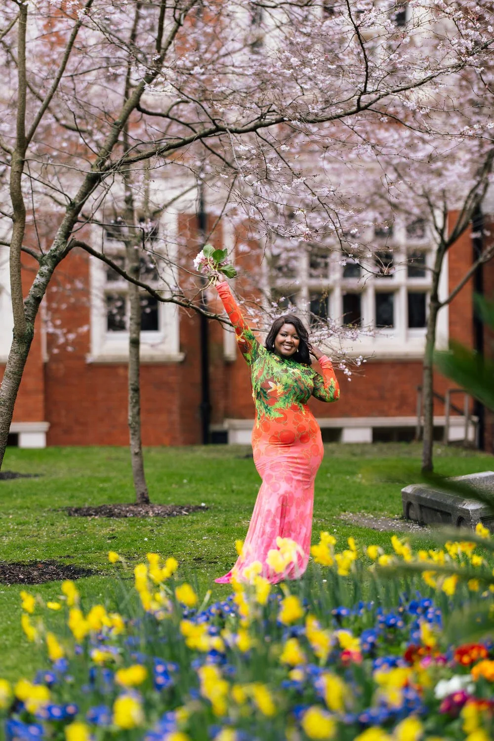 Woman poses joyfully in gorgeous gown during solo portrait photoshoot in Mayfair