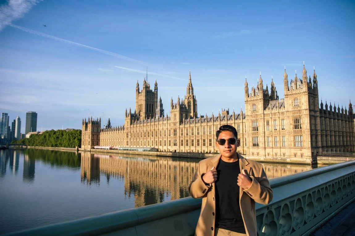 young man stands on Westminster Bridge for solo traveller photoshoot in London