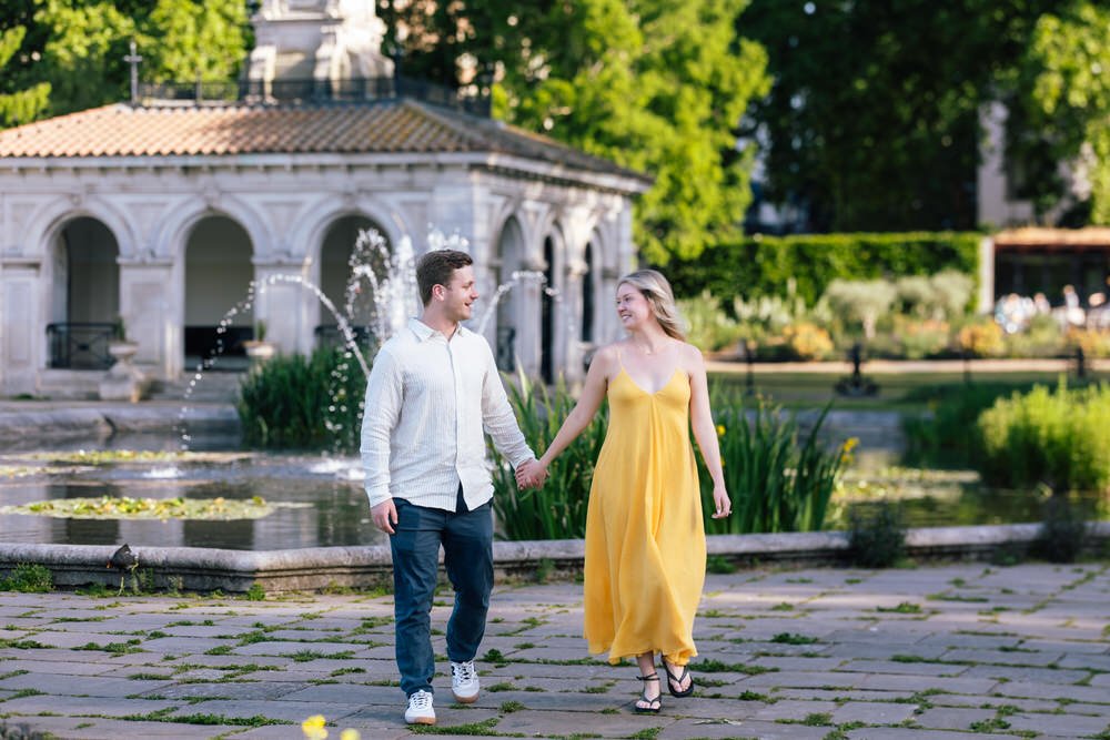 Couple hand in hand at the Italian Water Gardens in Kensington Gardens after Surprise Proposal at Italian Water Gardens London