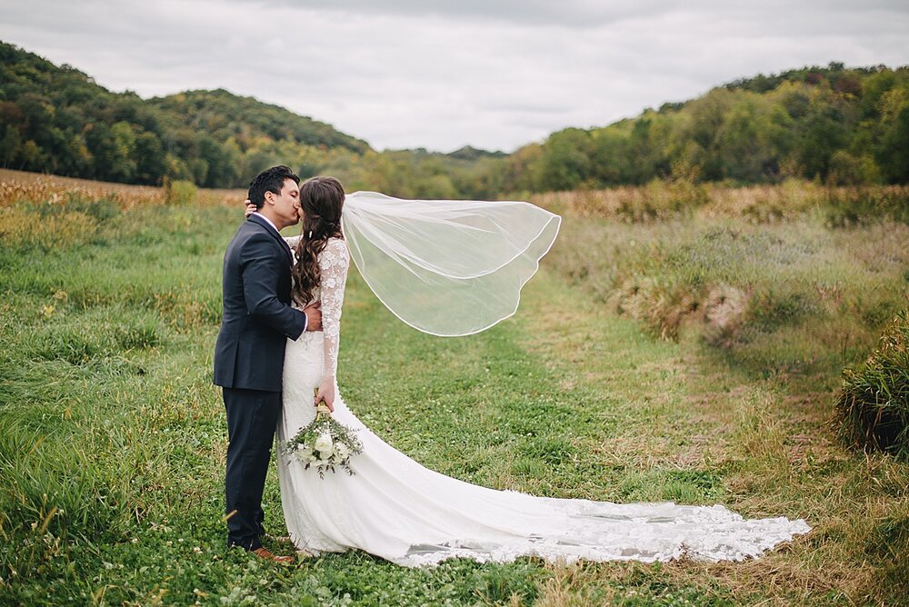 hidden-meadow-and-barn-wedding-couple-veil.jpg