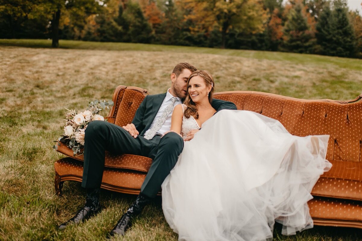 37_Bride and groom on orange couch.jpg