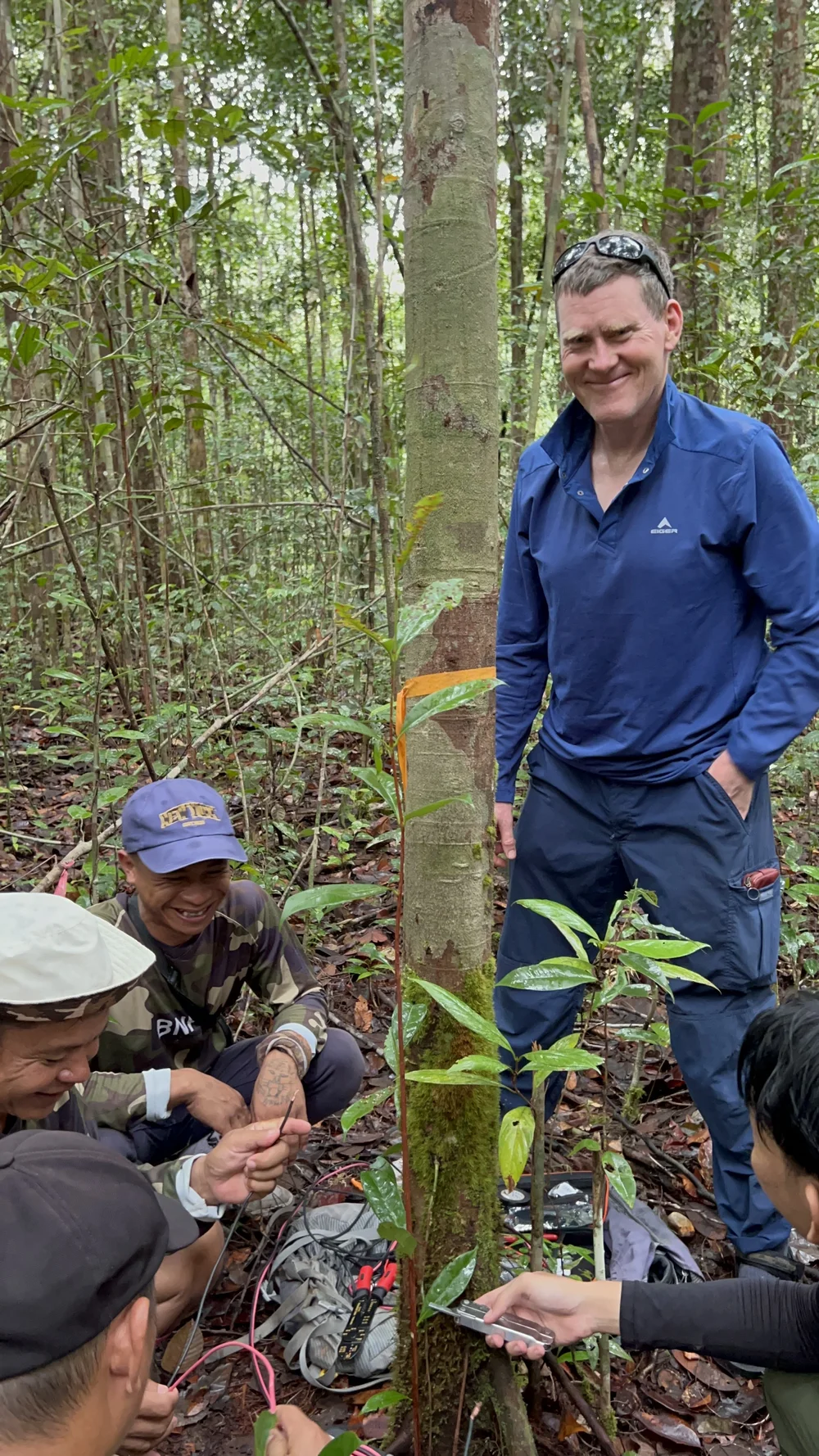  Jim McQuaid (University of Leeds collaborator) works with the field staff to install a PurpleAir monitor in the Mungku Baru Education and Research Forest 