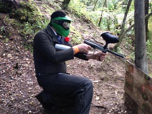 man in suit playing paintball at a stag party.jpg