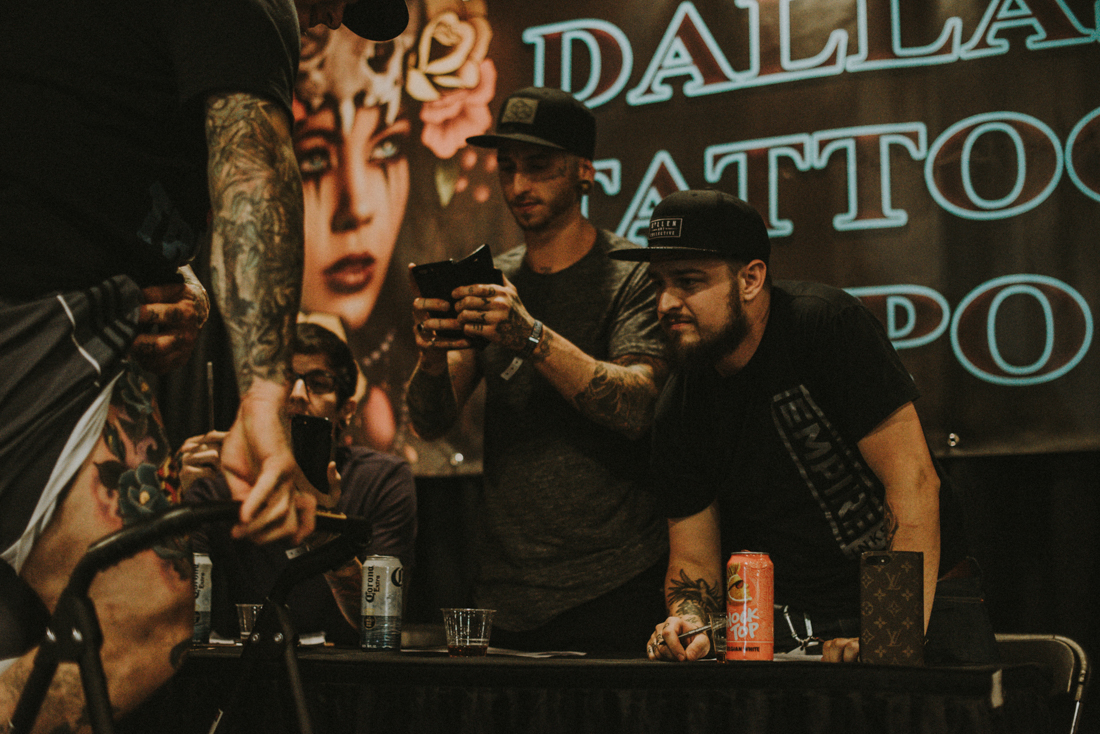 Andrés Acosta , Zack Singer , & Trent Vall eau looking over some submitted artwork.