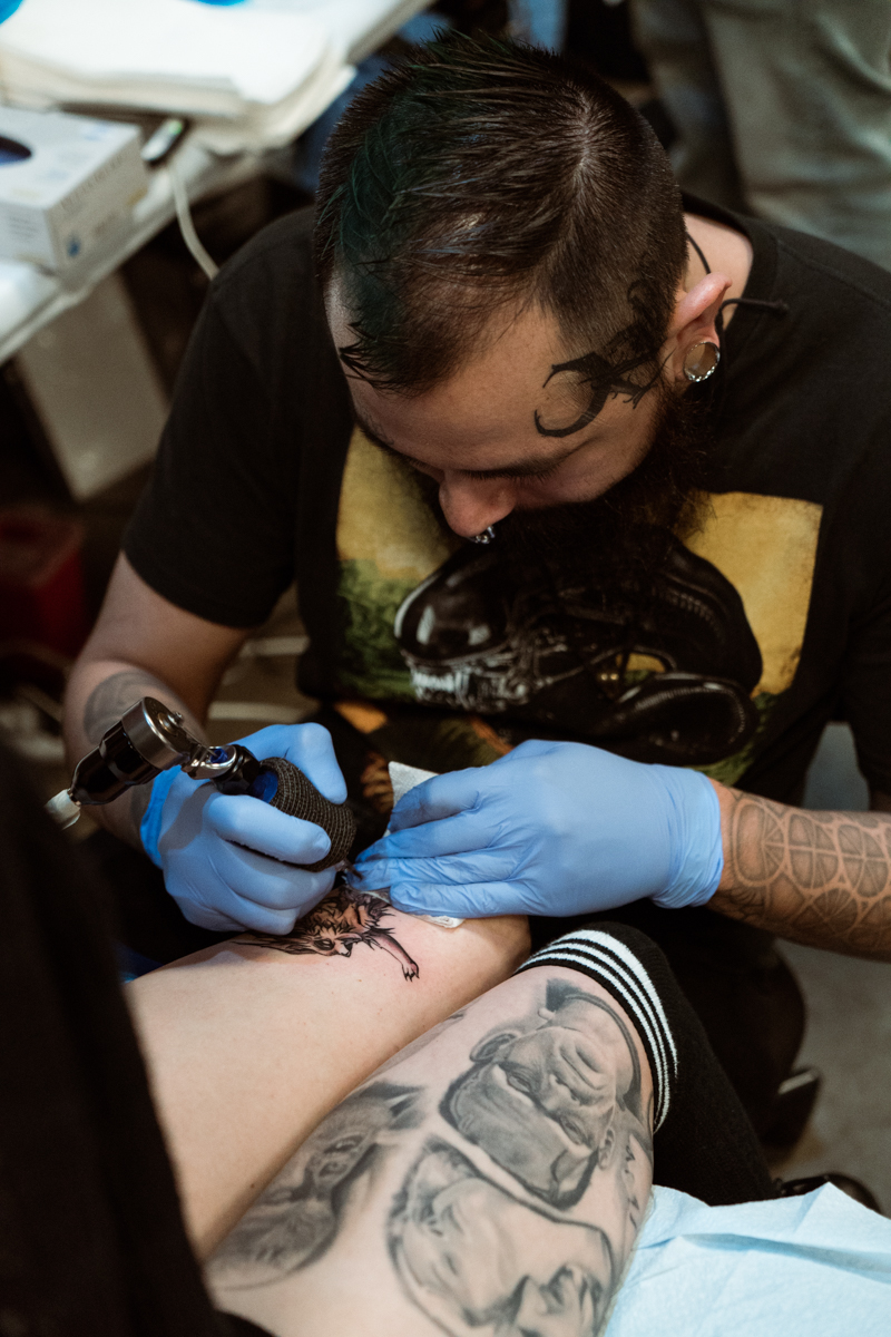 Armando Mena tattooing. Outside of convention, you can find him at Crimson Veil Tattoo in El Paso. His work is also featured in the current magazine issue! 