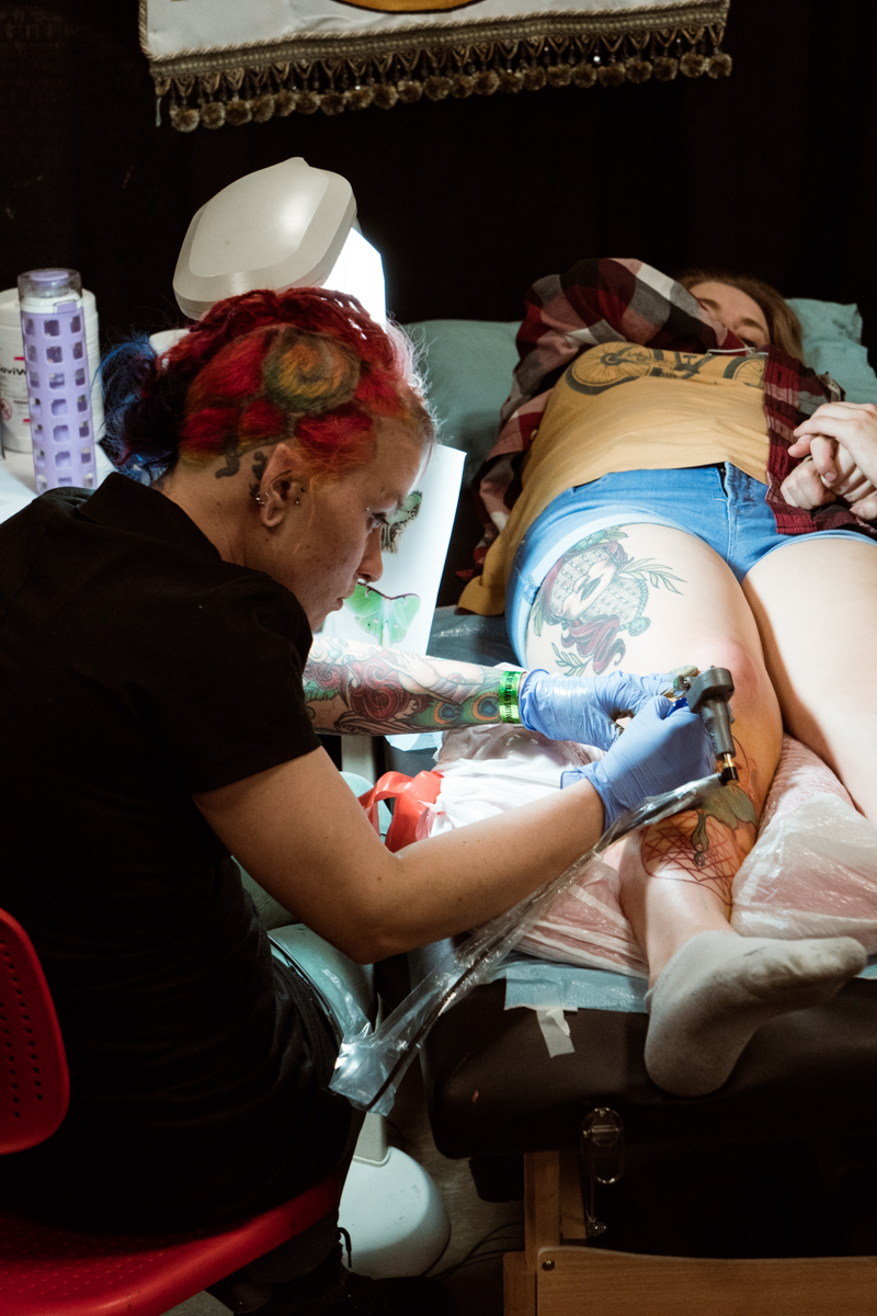  Tank Girl working on a beautiful luna moth shin piece. Find her at True Blue Tattoo in Austin 