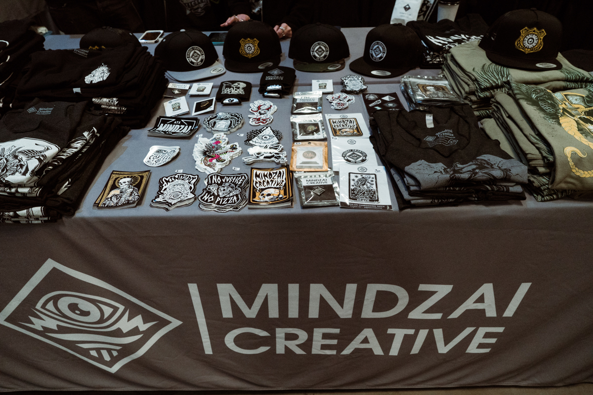  Mindzai Creative never misses a convention! This design &amp; print shop located in Austin tackles everything from pins,&nbsp;stickers, prints, screen printing and more. Go see them for all your printing needs. 