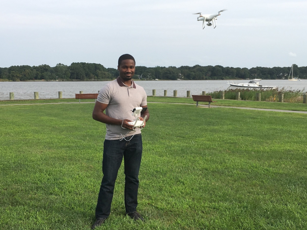 Shoge standing with drone in Wilmer Park in Chestertown, MD