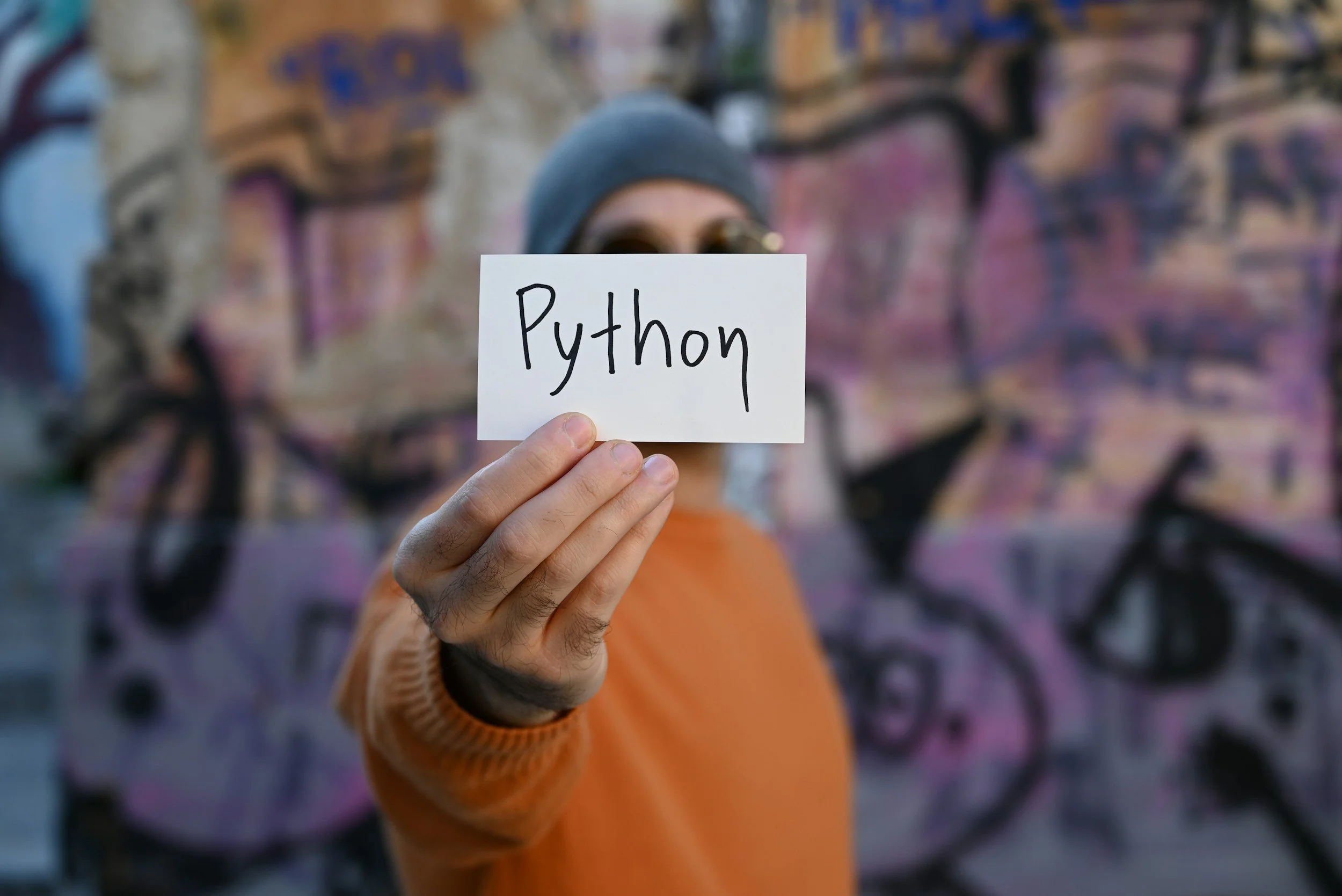 Teenager holding a handwritten Python sign