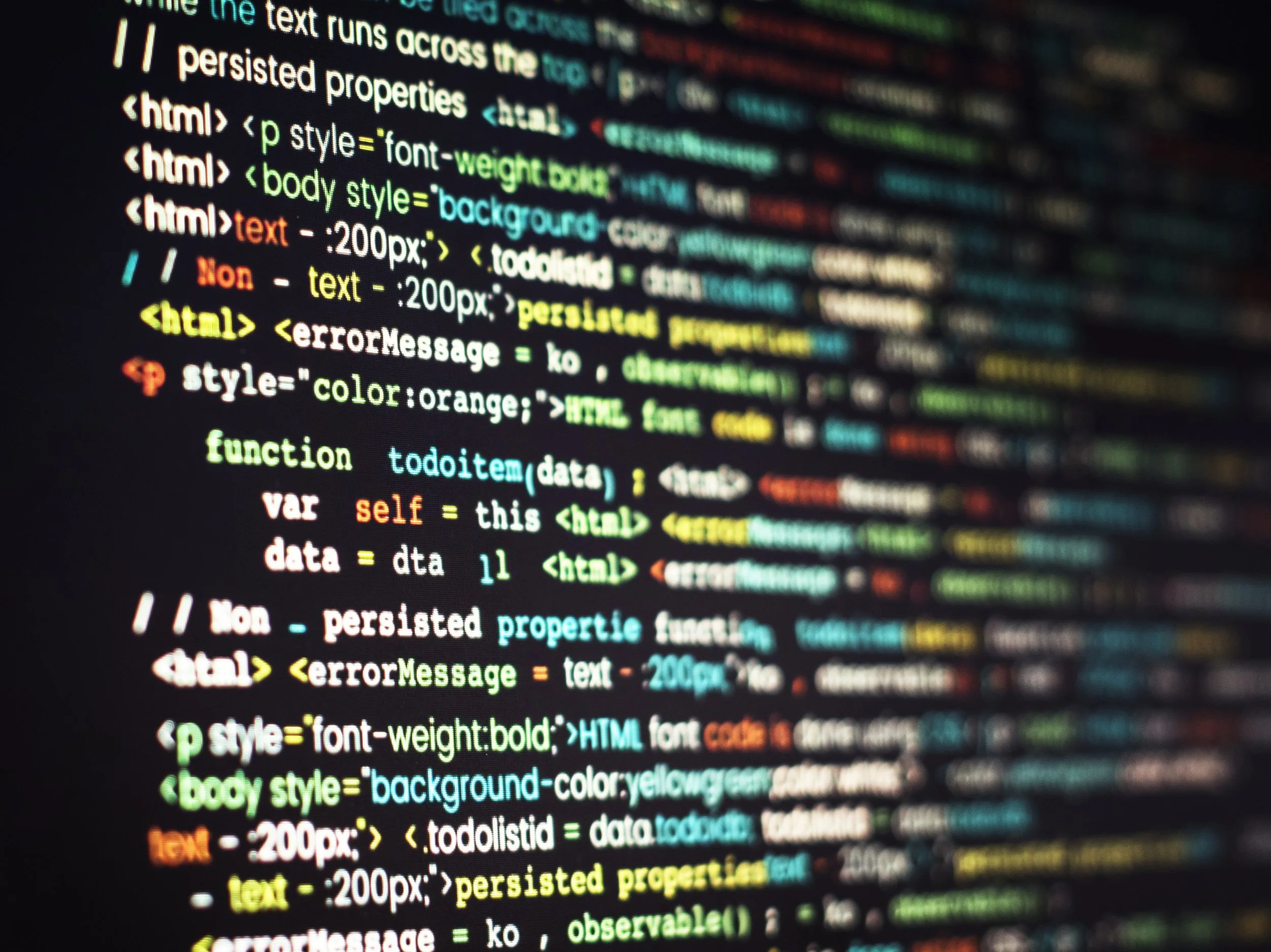 Close-up of colourful HTML and JavaScript code on a screen