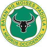 Badge with a bull skull in the center, surrounded by a green shield and a yellow border that reads 'Bayan ng Moises Padilla Negros Occidental'.