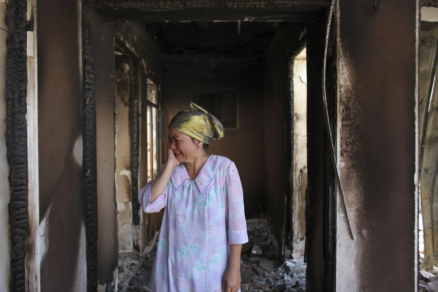 She burst into tears finding her home had been burned to the ground during sectarian violence - Kyrgyzstan.