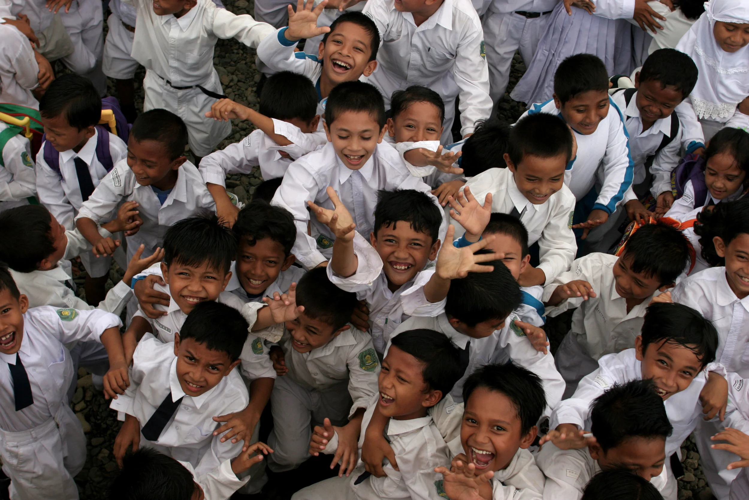 Children leap for joy as UNICEF School in a Box aid arrives at their school in the wake of the Indian Ocean Tsunami