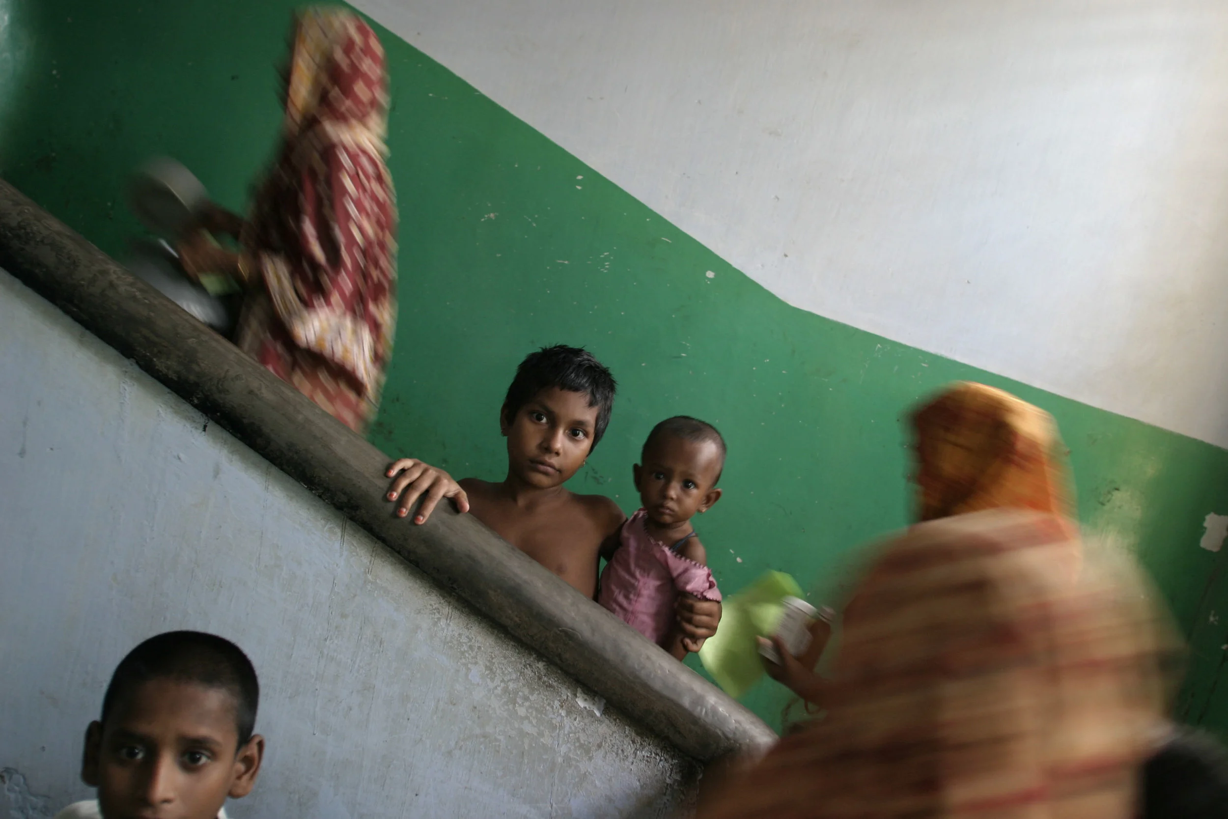 Family's seek refugee from flood waters at a school in Dhaka. The country was experiencing the worst flooding in 20 years.