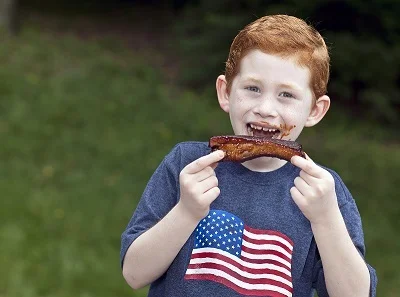 Boy-eating-a-BBQ-rib-outside-small.jpg