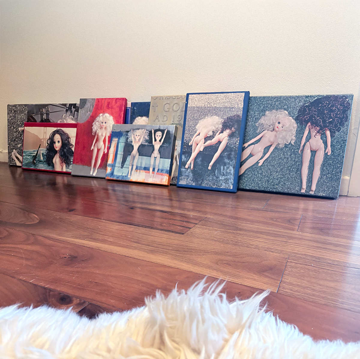 One-of-a-kind Paige & Ginger canvases on hardwood floor