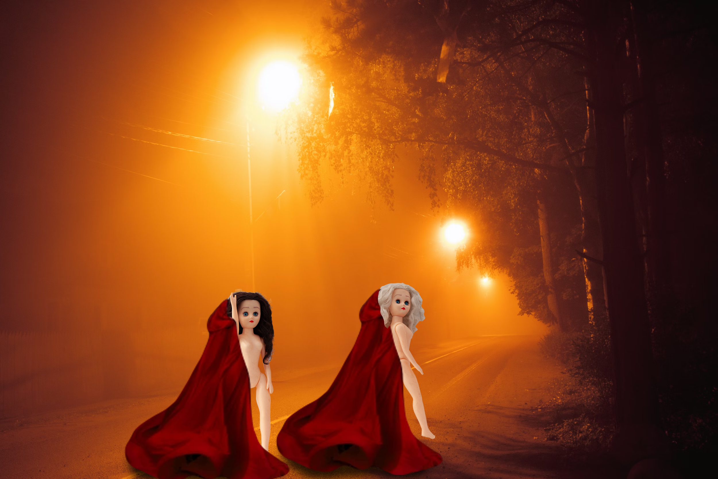 Paige and Ginger at night wearing red capes