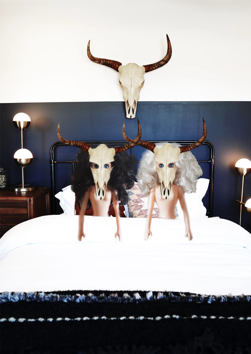 Paige and Ginger in bed wearing bull skulls on their heads