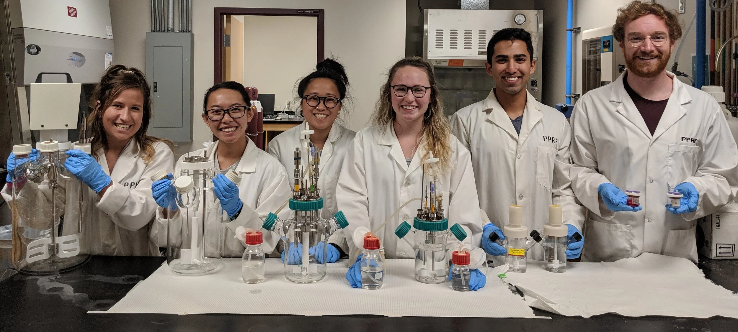 PPRF lab members pose for a photo with their bioreactors. From left: Breanna Borys, Tiffany Dang, Tania So, Alexis Pawluk, Sanchit Chopra, Brett Abraham. Brett and Tania are recent graduates of the Chemical Engineering program at UofC (BME Specialization), and Tiffany, Alexis, and Sanchit, are undergraduates in the program.